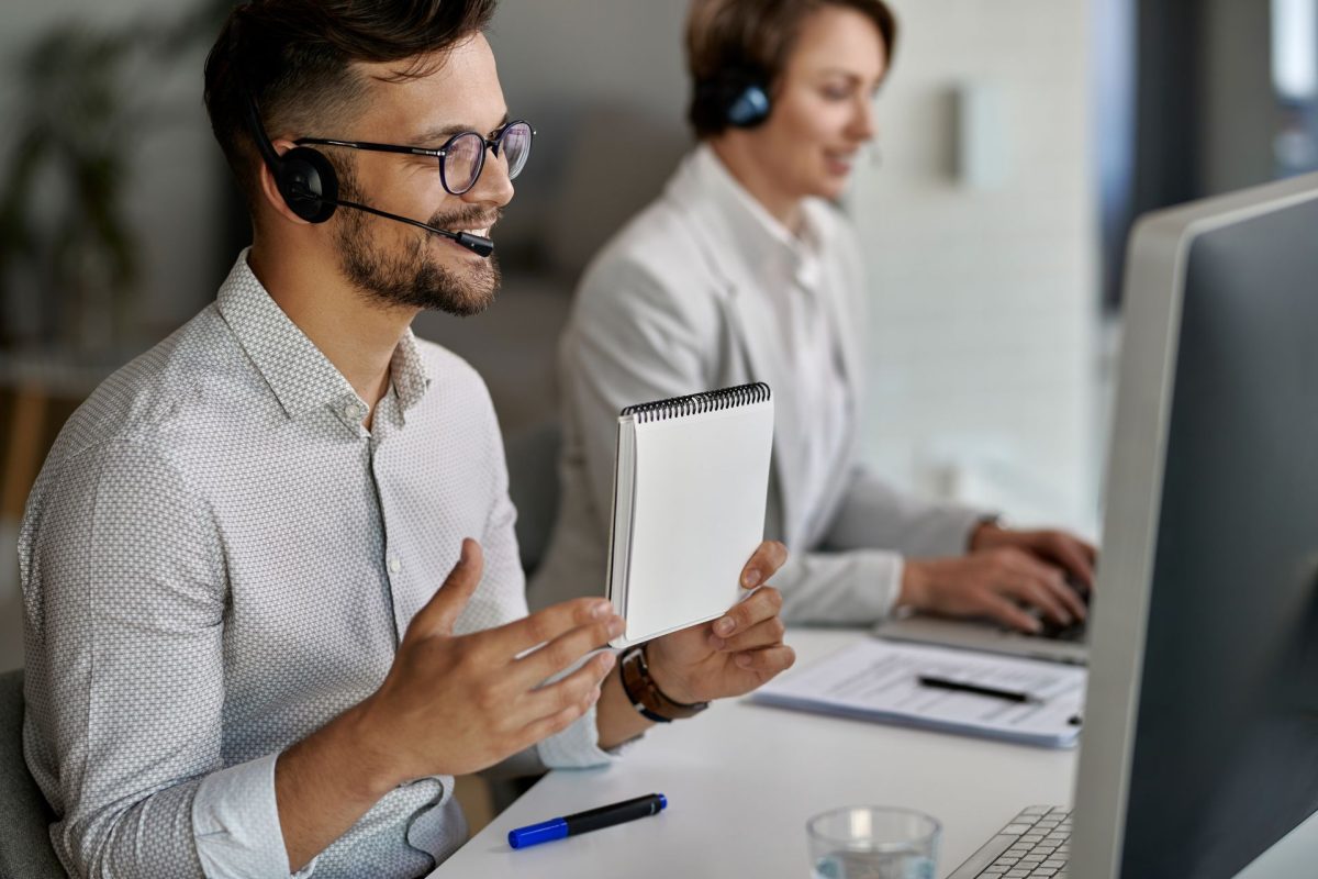 Happy customer service representative using computer having video call with clients while working call center result